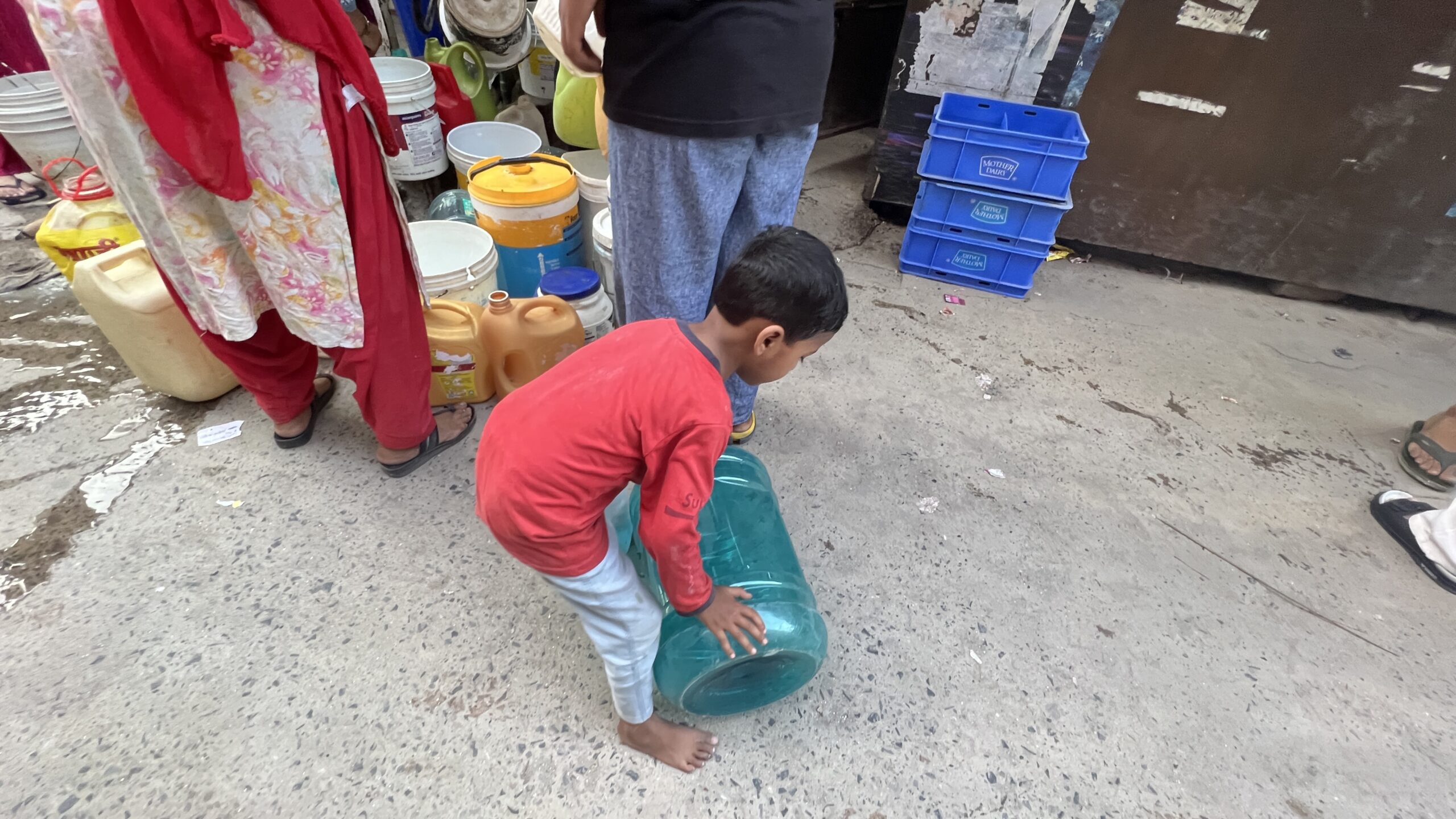 Even children help when it comes to filling water. Subhash Camp, Dakshinpuri. Summer, 2026. Even children help when it comes to filling water. Subhash Camp, Dakshinpuri. Summer, 2026.