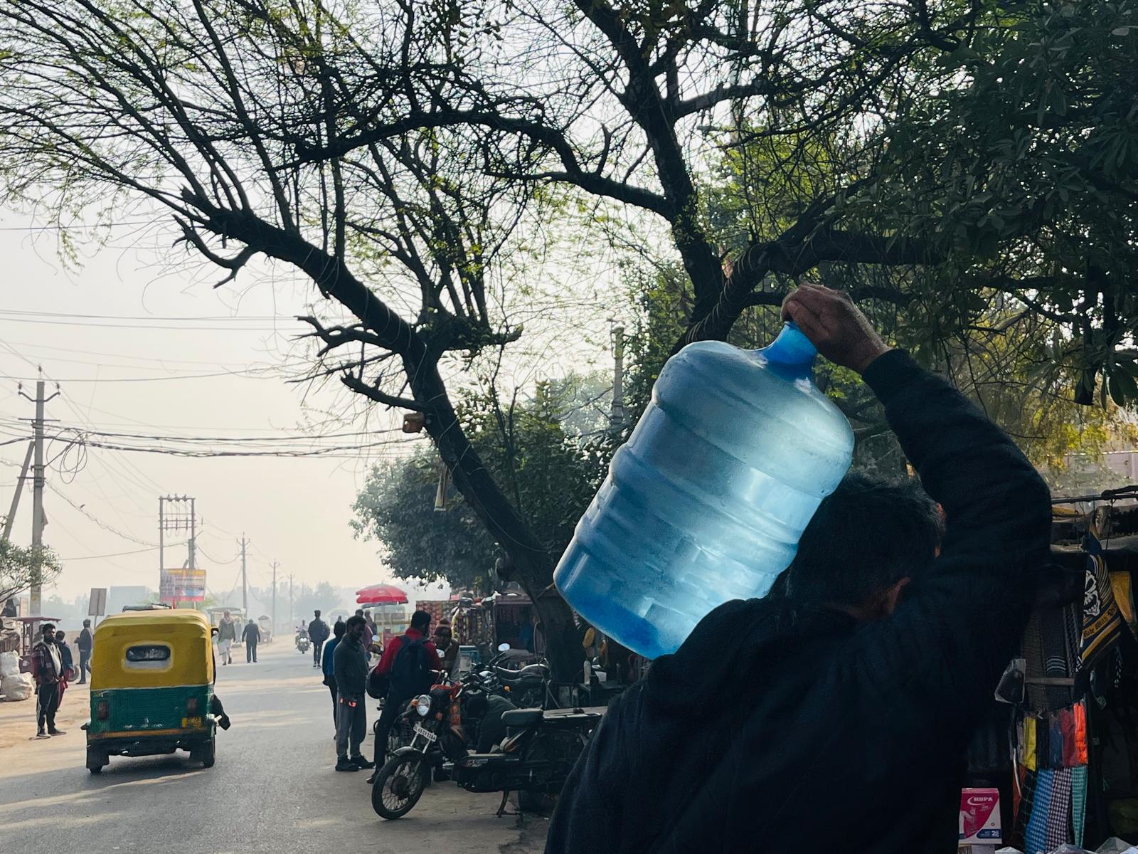 A man carries a filled water can on his shoulder. Savda 2025. A man carries a filled water can on his shoulder. Savda 2025.